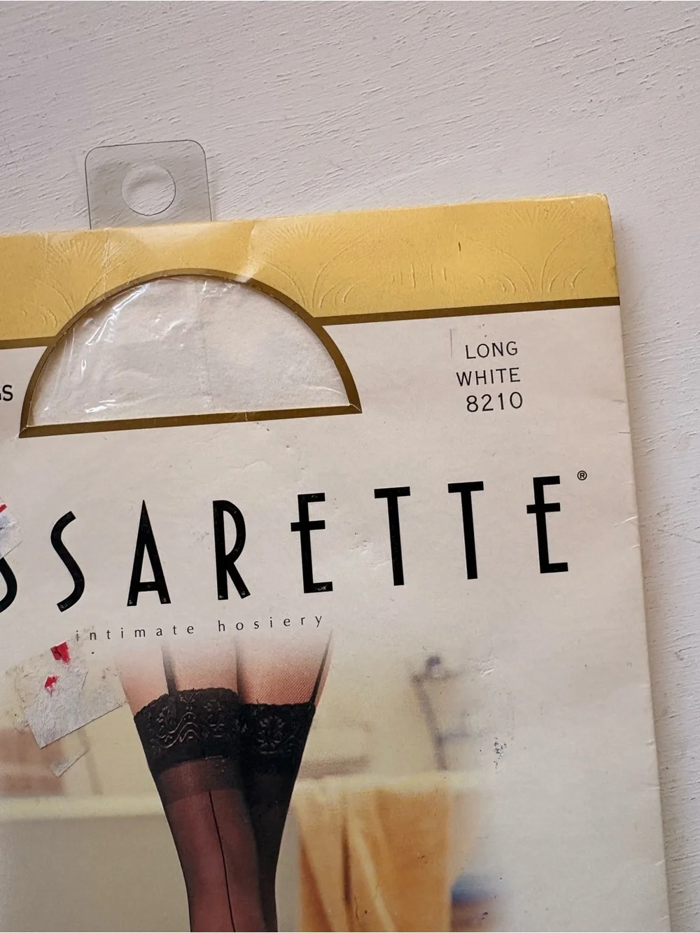 vassarette White & Gold Hosiery Packaging with Black Stocking Image